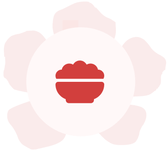 A red and white flower with a bowl of food in the middle.